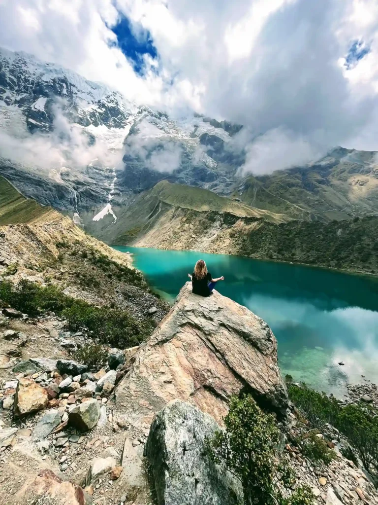 Inca Trail alternatyvos: kaip pasiekti Maču Pikču be leidimų loterijos Moteris medituo ant uolos virš Humantay ežero, Andai, Peru
