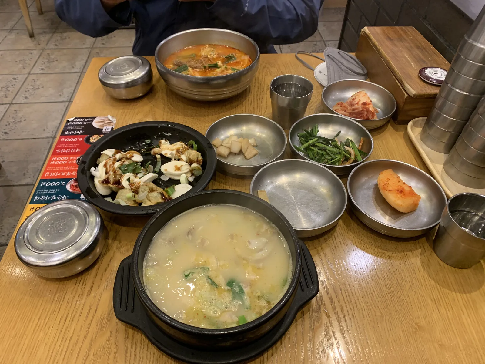 Doenjang jjigae — fermentuotų sojų pastos sriuba akmens puode su banchan priedais